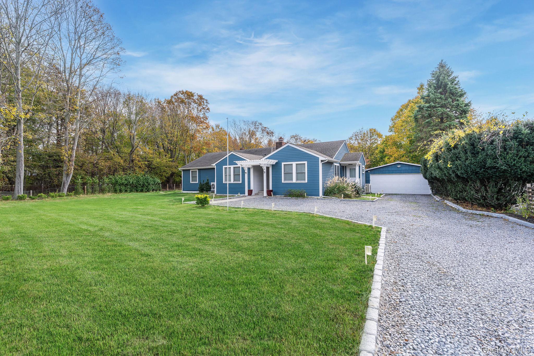 10940 Main Road East Marion, NY 11939 - Photo 3 of 38 a front view of a house with garden
