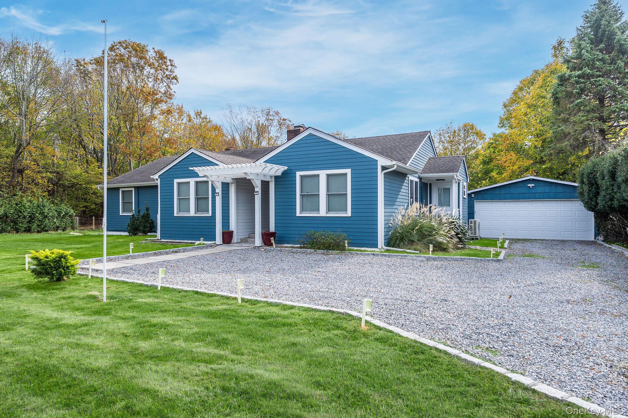 10940 Main Road East Marion, NY 11939 - Photo 31 of 38 a view of a yard in front of a house with plants and large tree