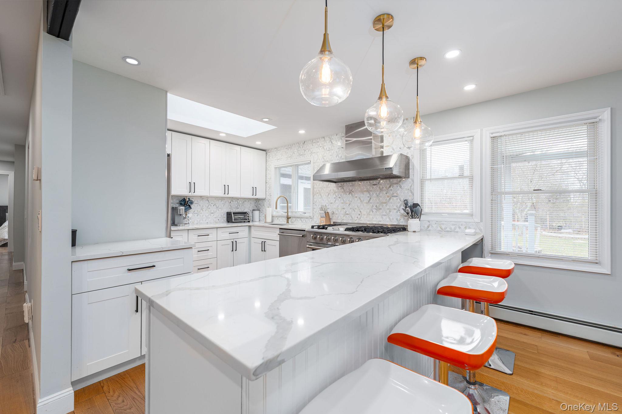 10940 Main Road East Marion, NY 11939 - Photo 6 of 38 a kitchen with counter and windows