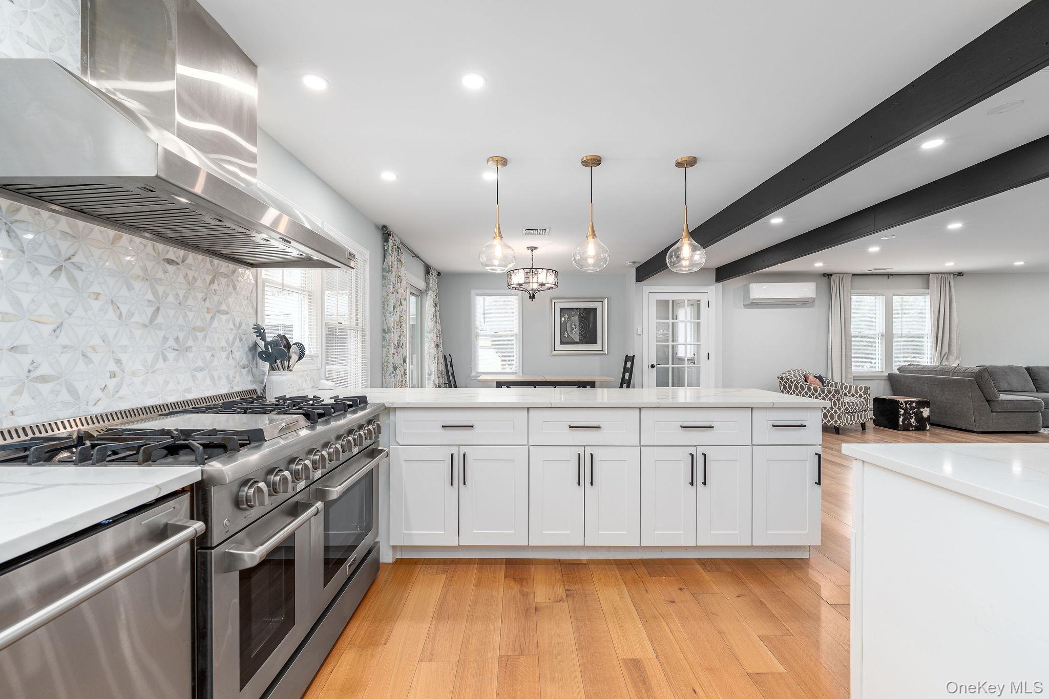 10940 Main Road East Marion, NY 11939 - Photo 9 of 38 a kitchen with stainless steel appliances granite countertop a stove a sink dishwasher and a refrigerator