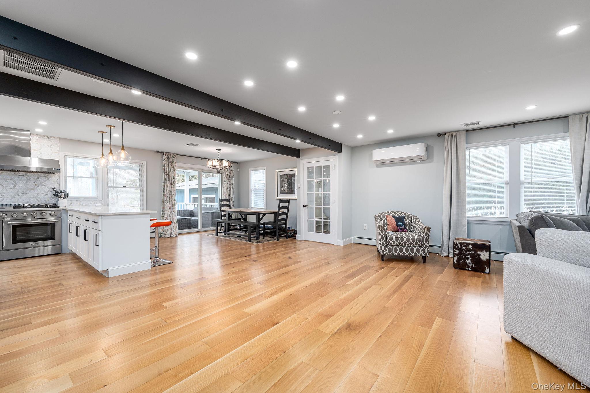 10940 Main Road East Marion, NY 11939 - Photo 10 of 38 a living room with furniture and a large window