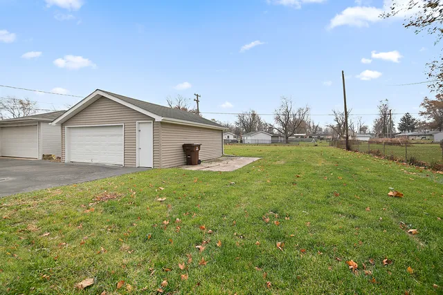 a view of a house with a backyard and a tree