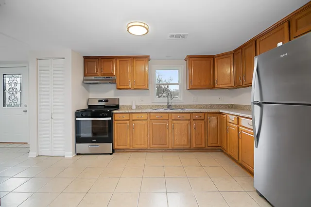 a kitchen with a sink a stove and refrigerator
