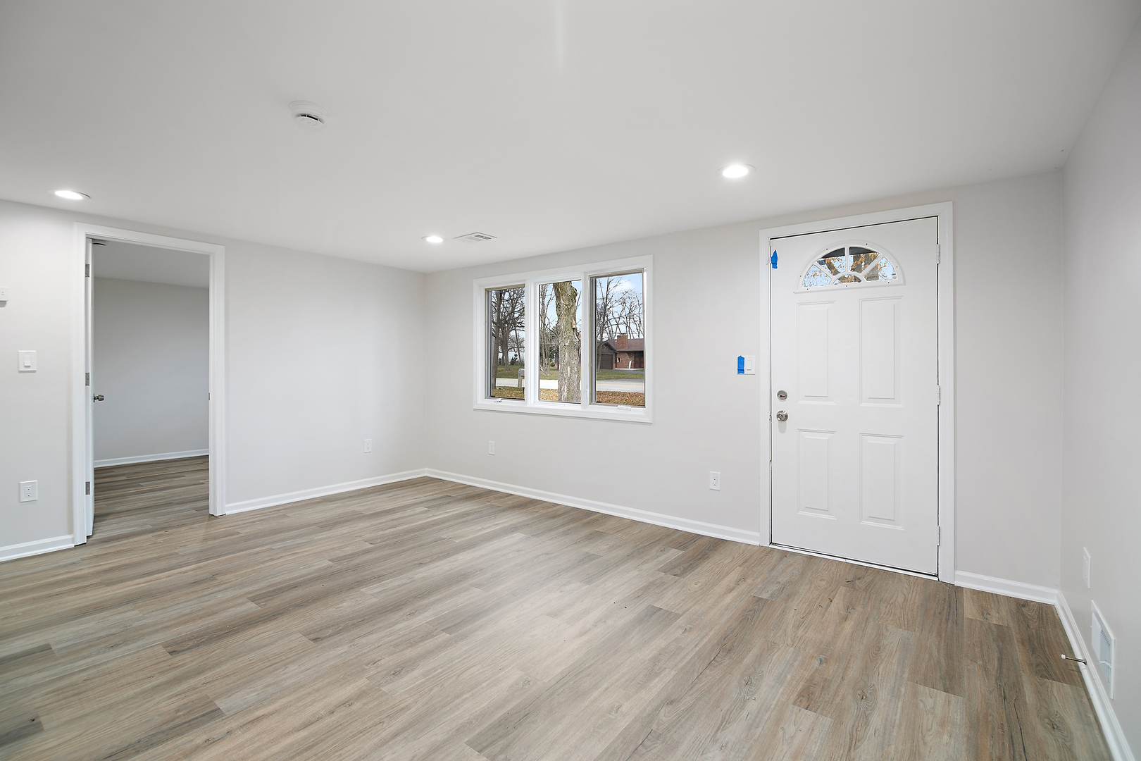 749 West New Monee Road Crete, IL 60417 - Photo 6 of 17 a view of an empty room with wooden floor and a window