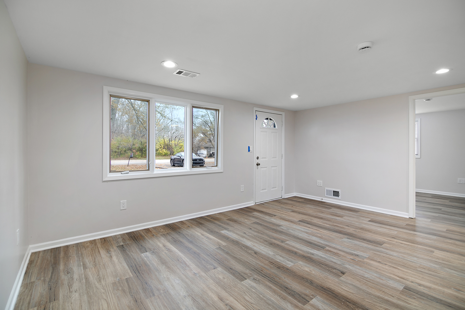 749 West New Monee Road Crete, IL 60417 - Photo 7 of 17 a view of an empty room with wooden floor and a window