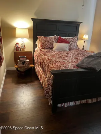 a bedroom with a bed and a night stand