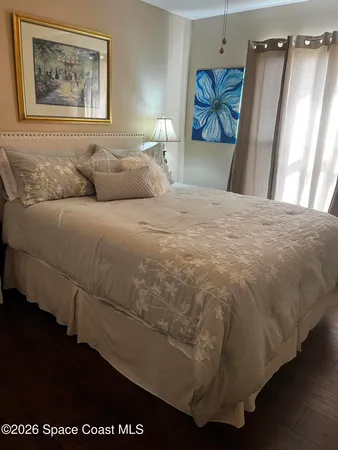 a bedroom with a bed and a painting on the wall
