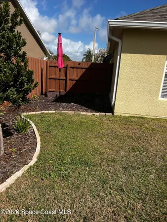 a view of a backyard of the house