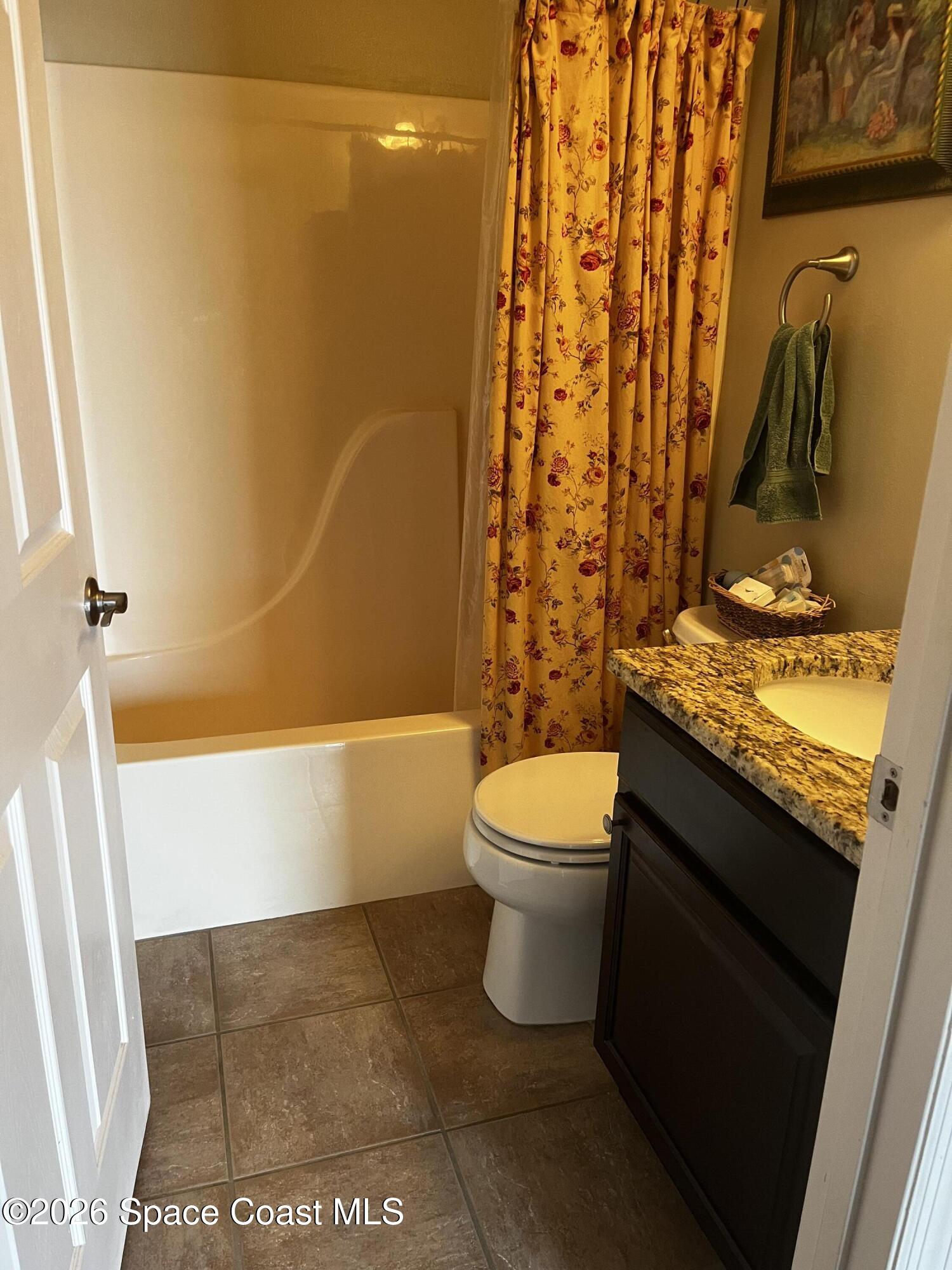 1219 Walnut Grove Way Rockledge, FL 32955 - Photo 15 of 23 a bathroom with a granite countertop bathtub shower sink and toilet