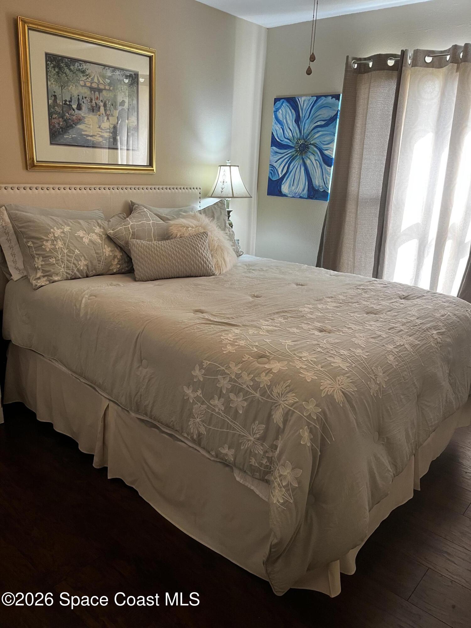 1219 Walnut Grove Way Rockledge, FL 32955 - Photo 17 of 23 a bedroom with a bed and a painting on the wall