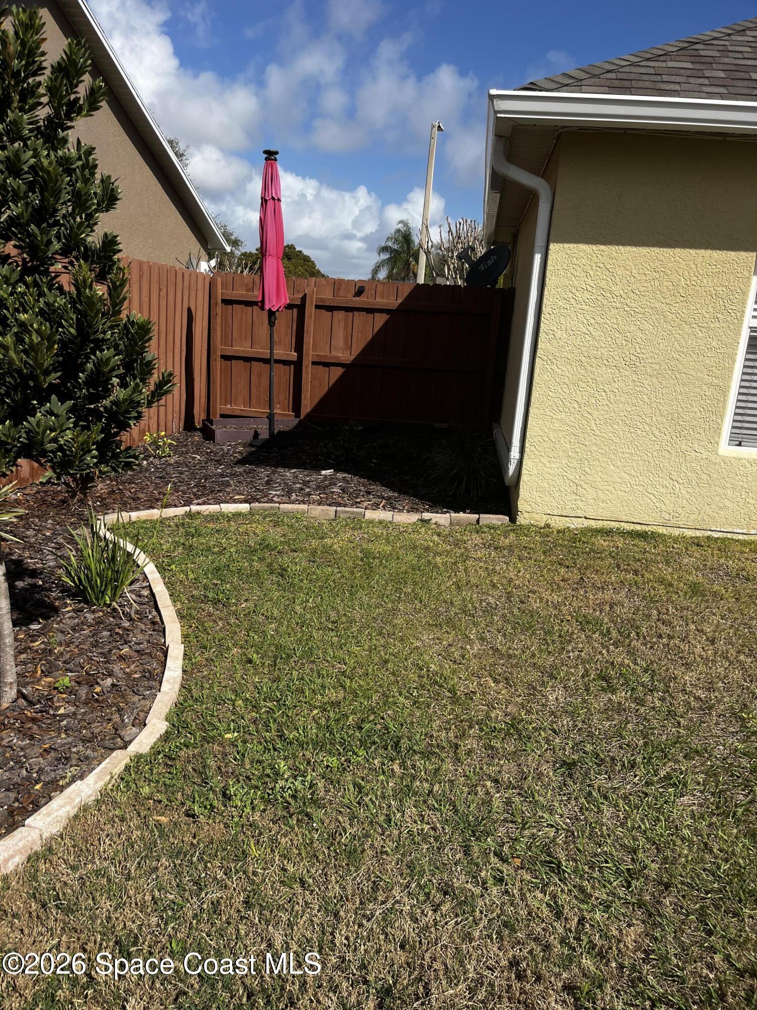 1219 Walnut Grove Way Rockledge, FL 32955 - Photo 19 of 23 a view of a backyard of the house