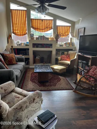 a living room with furniture fireplace and a flat screen tv