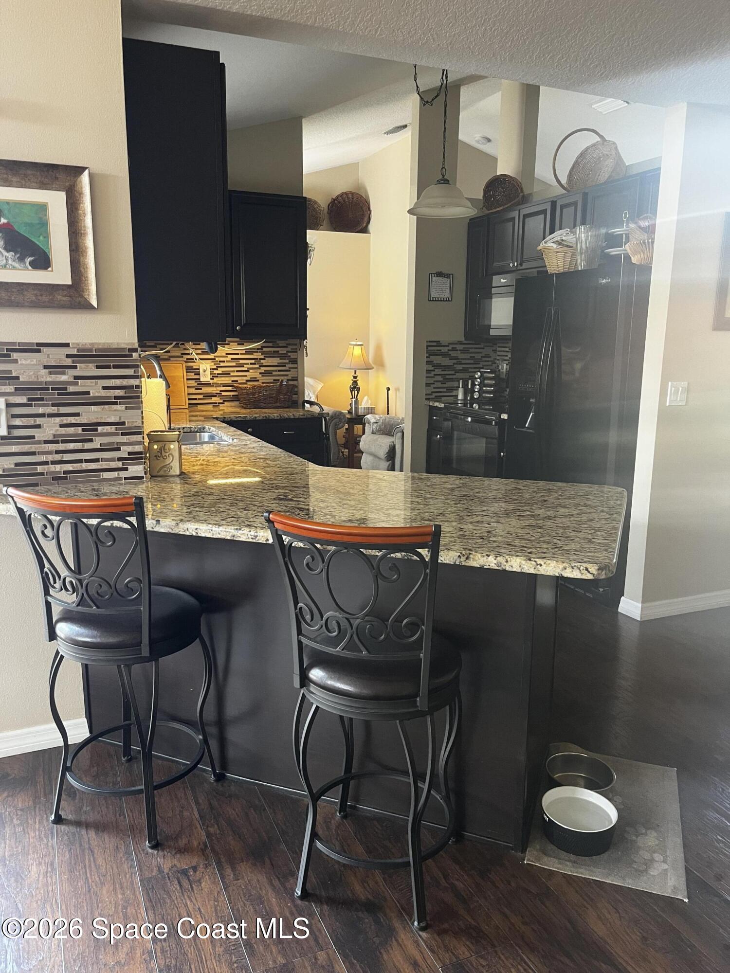 1219 Walnut Grove Way Rockledge, FL 32955 - Photo 6 of 23 a dining room with furniture and wooden floor