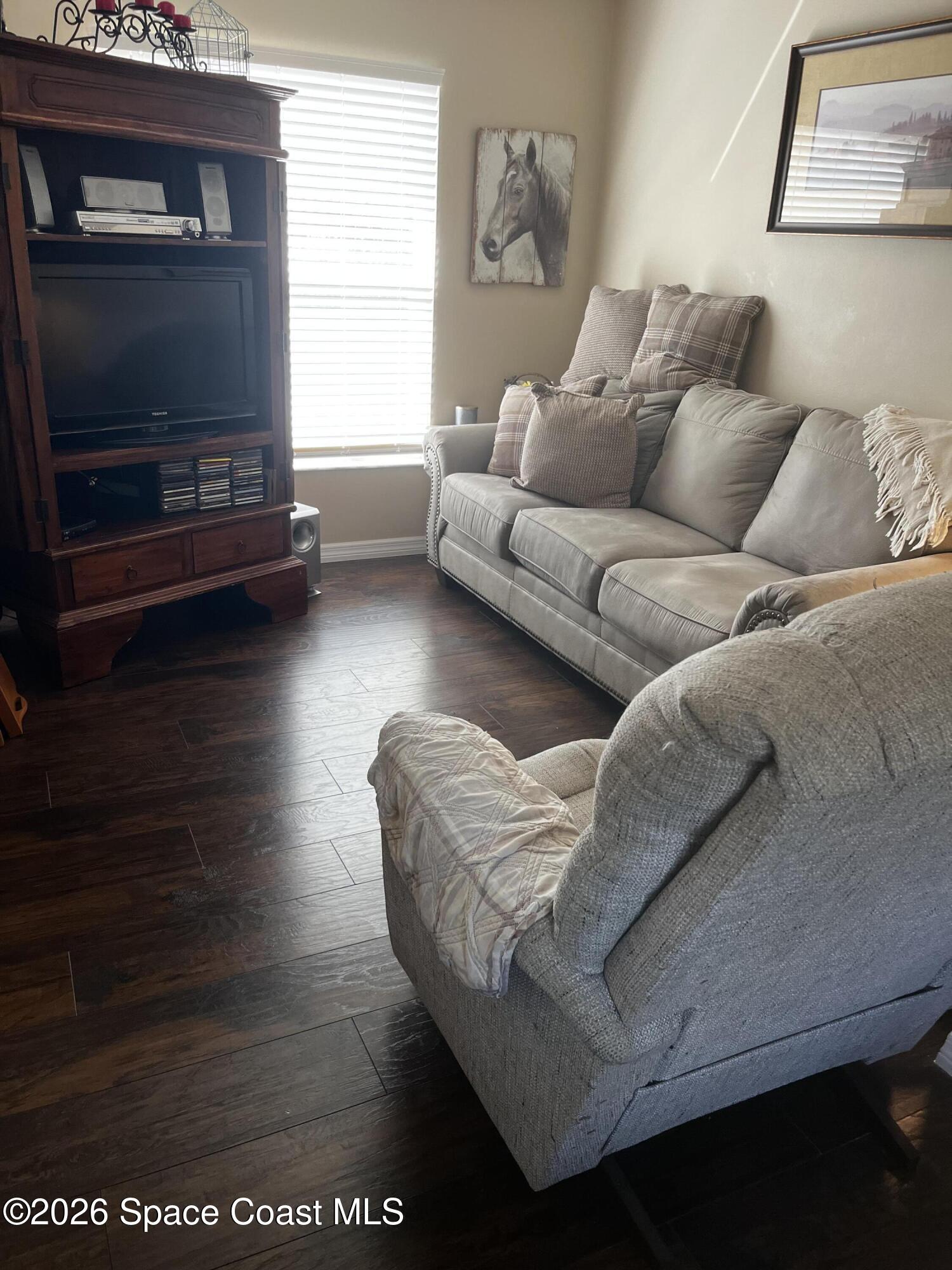 1219 Walnut Grove Way Rockledge, FL 32955 - Photo 9 of 23 a living room with furniture and a flat screen tv