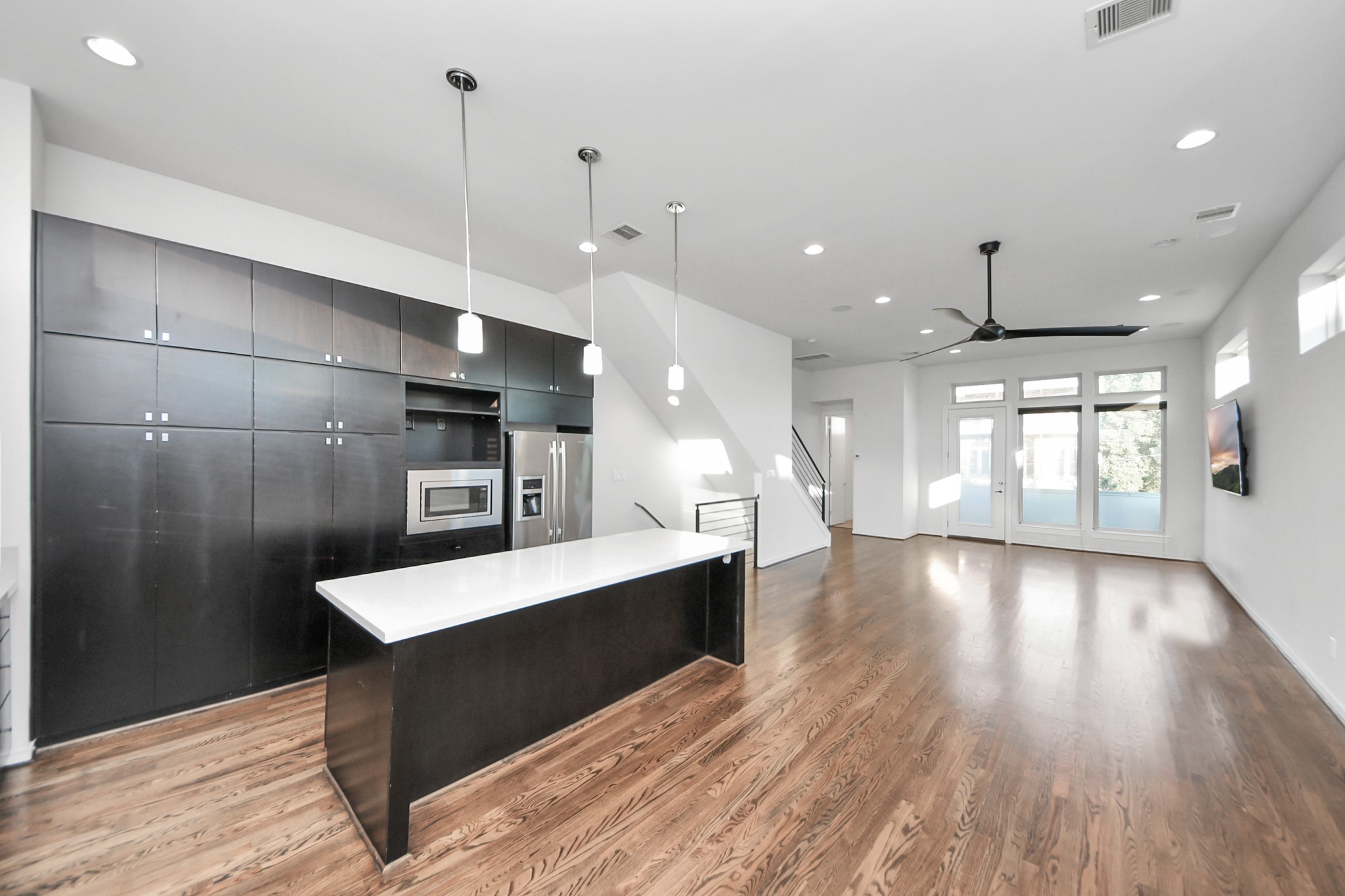 1315 Nagle Street Houston, TX 77003 - Photo 12 of 29 a large kitchen with a large window a refrigerator and wooden floor