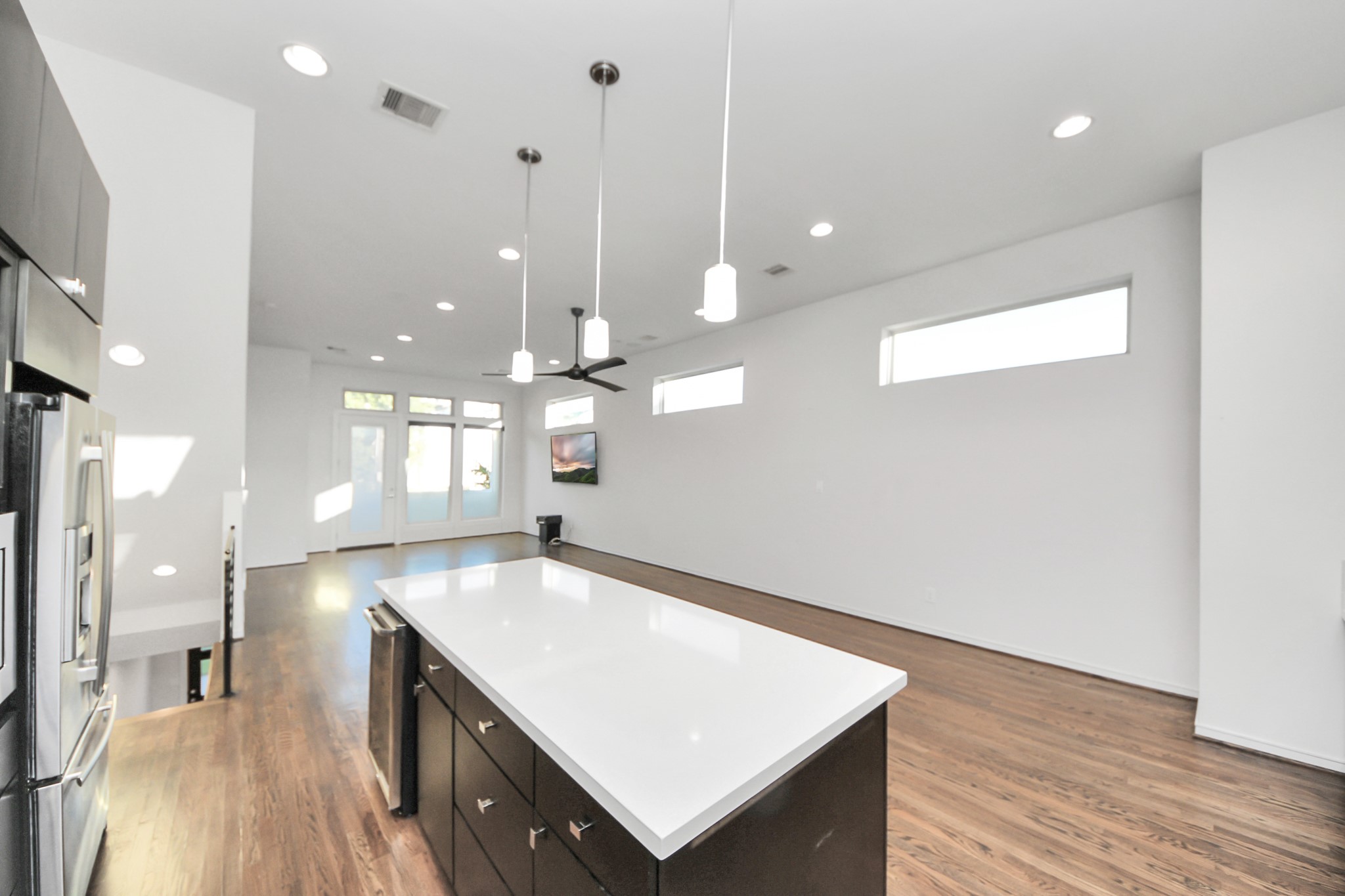 1315 Nagle Street Houston, TX 77003 - Photo 13 of 29 a large kitchen with stainless steel appliances a large counter top a refrigerator and a wooden floor