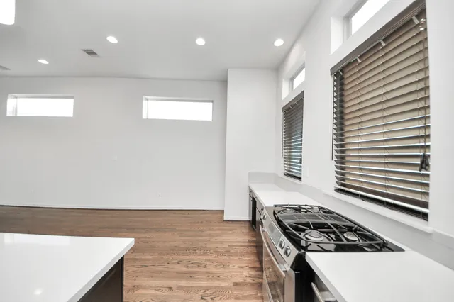 a kitchen with stainless steel appliances granite countertop a stove a sink and a refrigerator