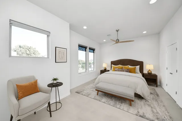 a bedroom with a bed and a chair