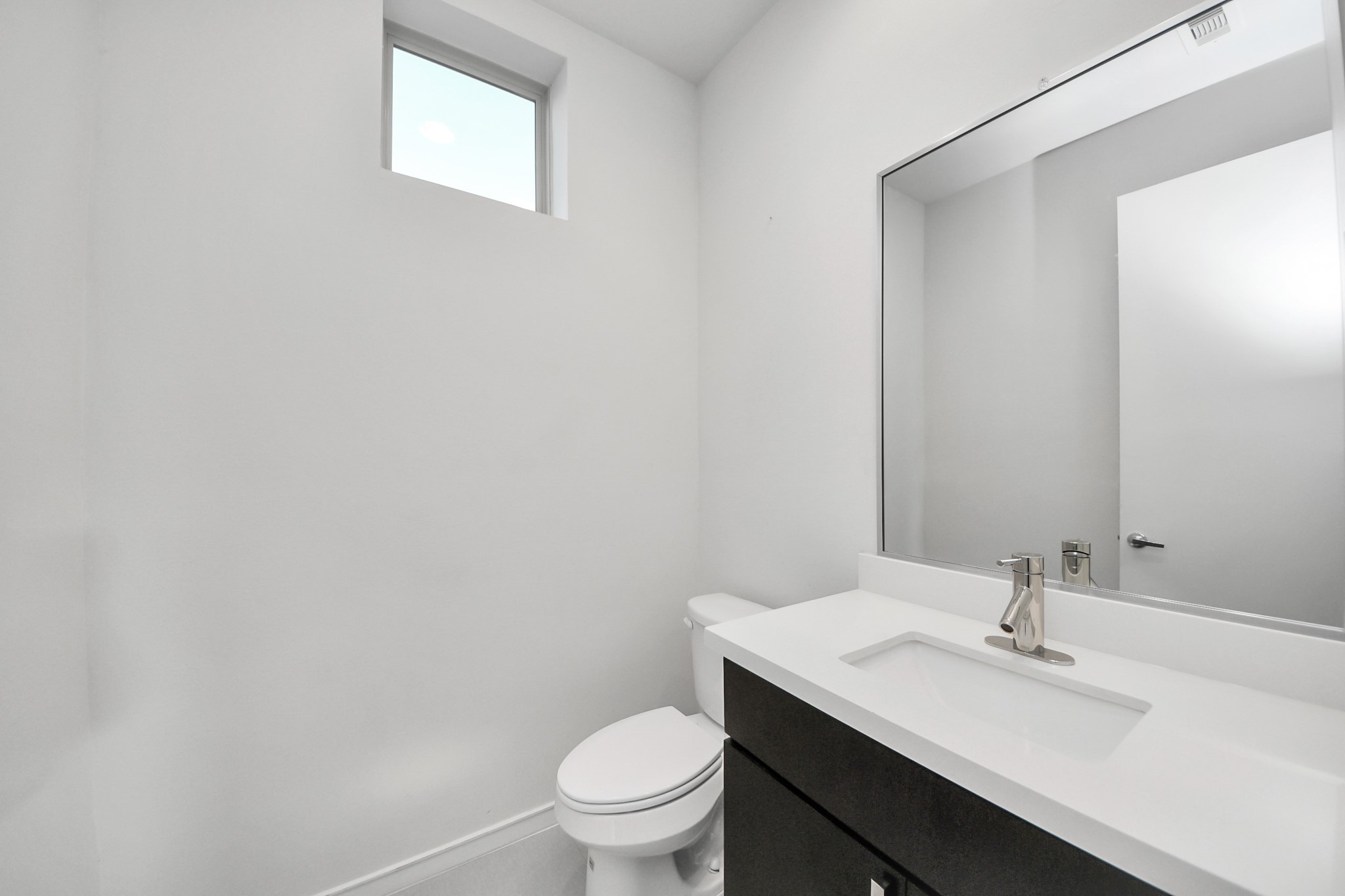 1315 Nagle Street Houston, TX 77003 - Photo 17 of 29 a bathroom with a sink a toilet and a mirror