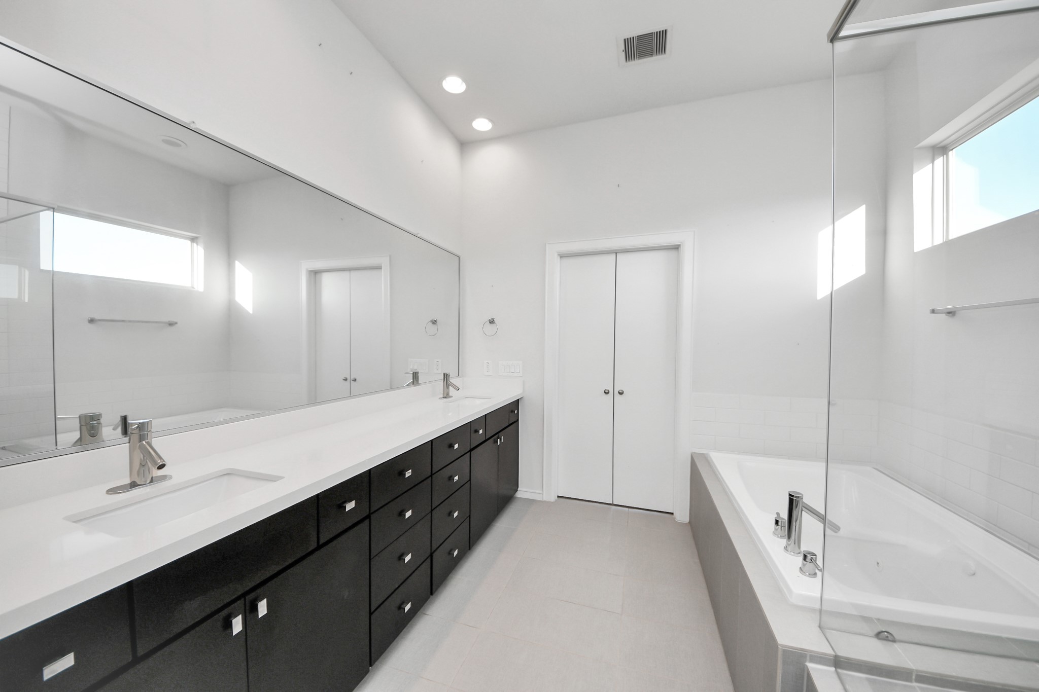 1315 Nagle Street Houston, TX 77003 - Photo 22 of 29 a spacious bathroom with a double vanity sink a mirror and a bathtub