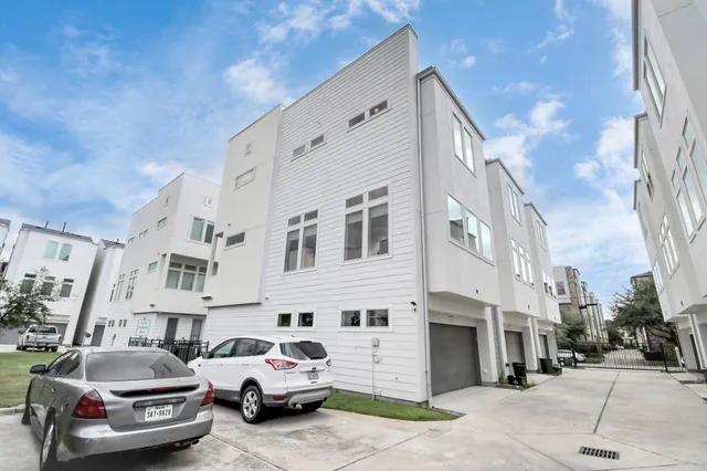 a view of a cars park in front of a building