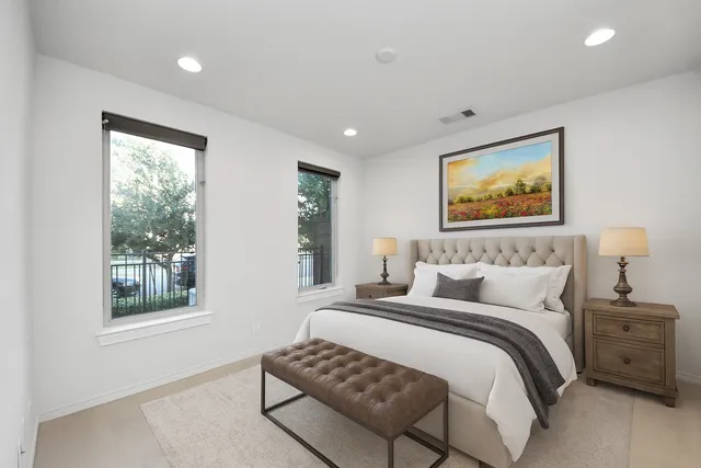 a bedroom with a bed and a painting on the wall