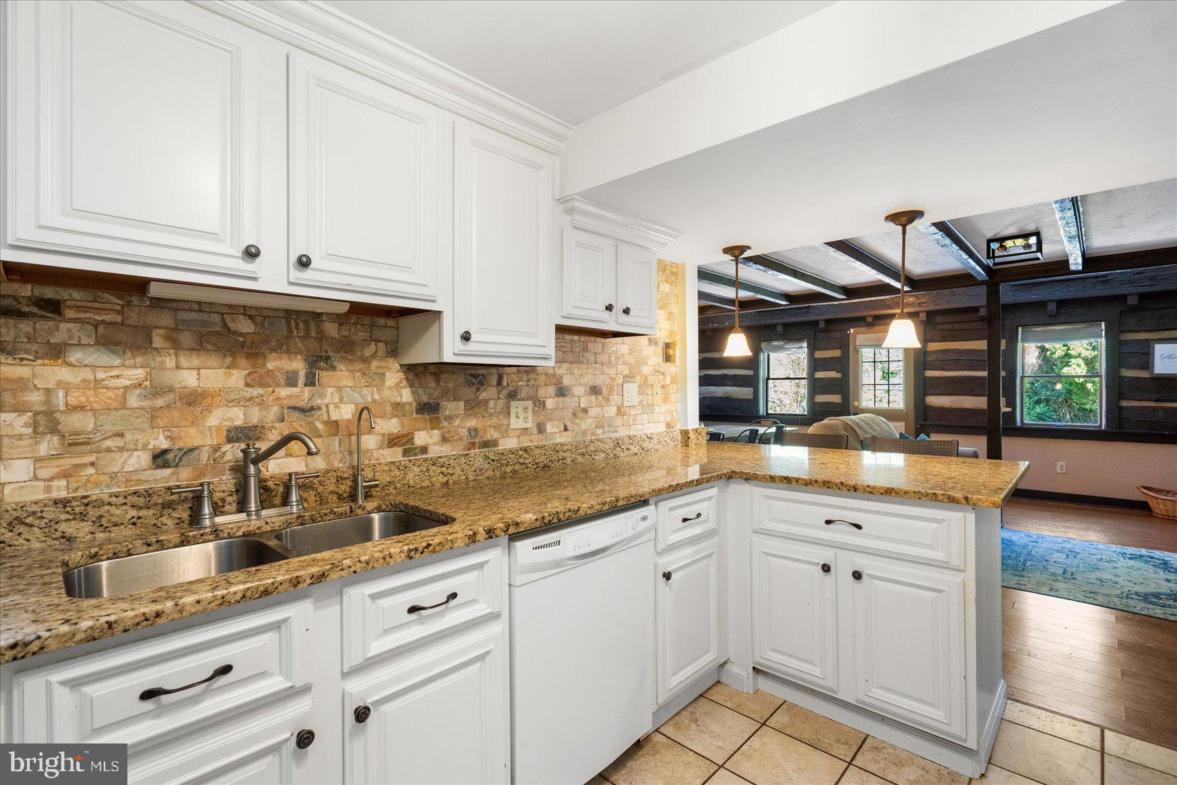972 Bird River Beach Road Middle River, MD 21220 - Photo 11 of 50 a kitchen with granite countertop white cabinets and white appliances