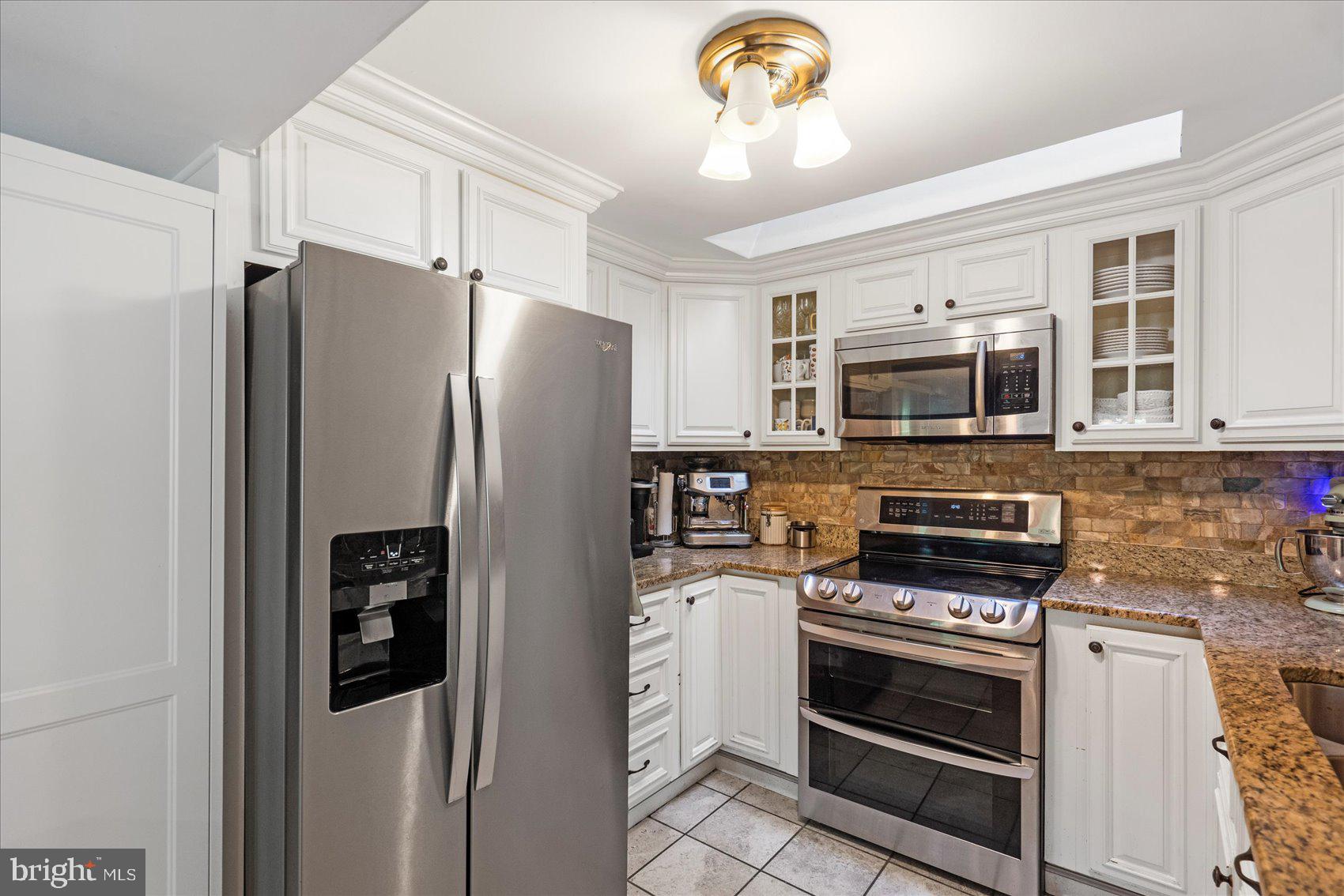 972 Bird River Beach Road Middle River, MD 21220 - Photo 13 of 50 a kitchen with stainless steel appliances a refrigerator stove and microwave