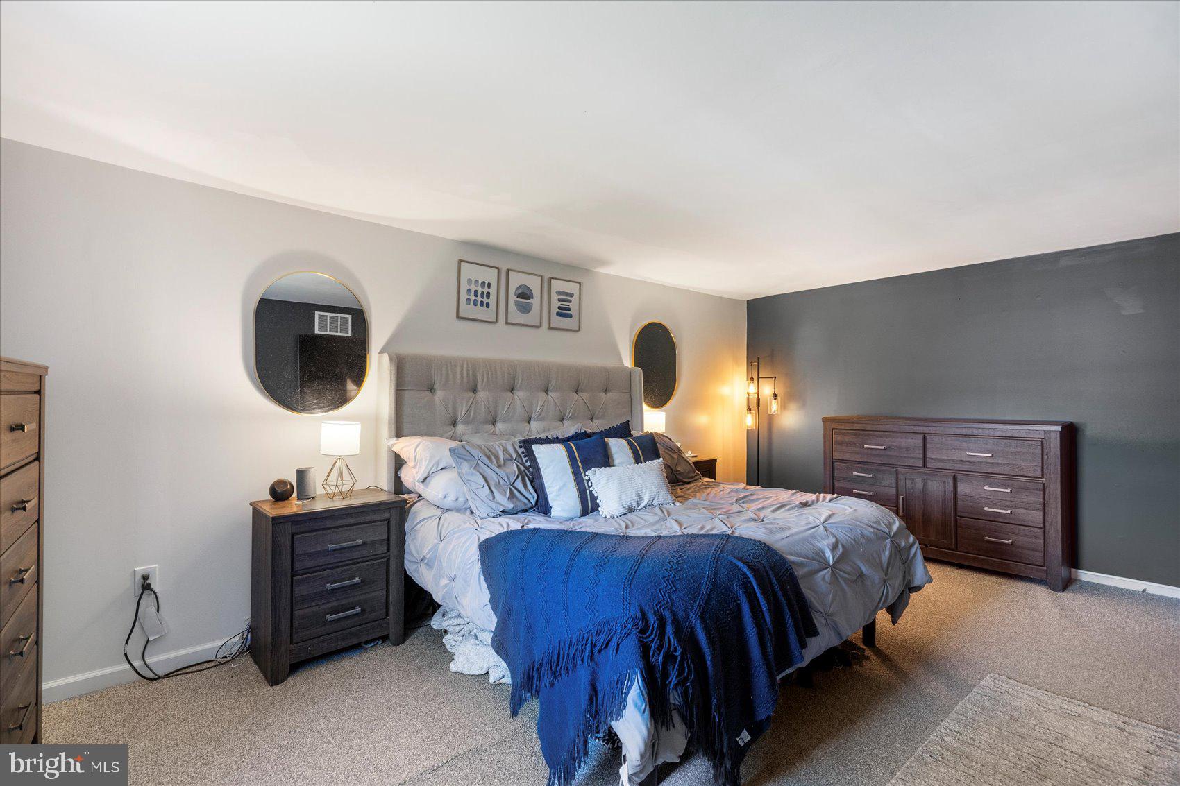 972 Bird River Beach Road Middle River, MD 21220 - Photo 20 of 50 a bedroom with a bed and dresser with mirror