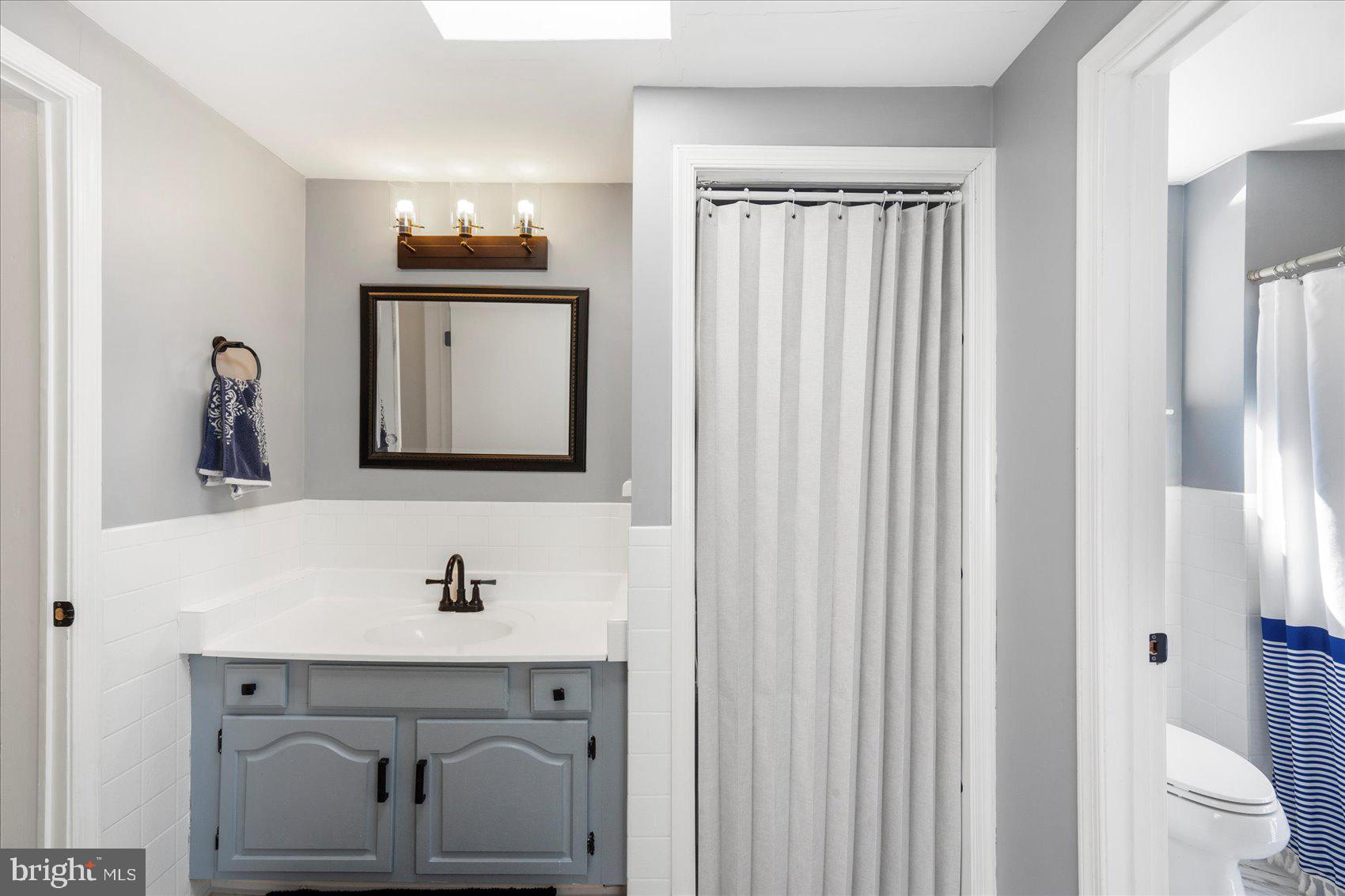972 Bird River Beach Road Middle River, MD 21220 - Photo 23 of 50 a bathroom with a sink vanity and a mirror