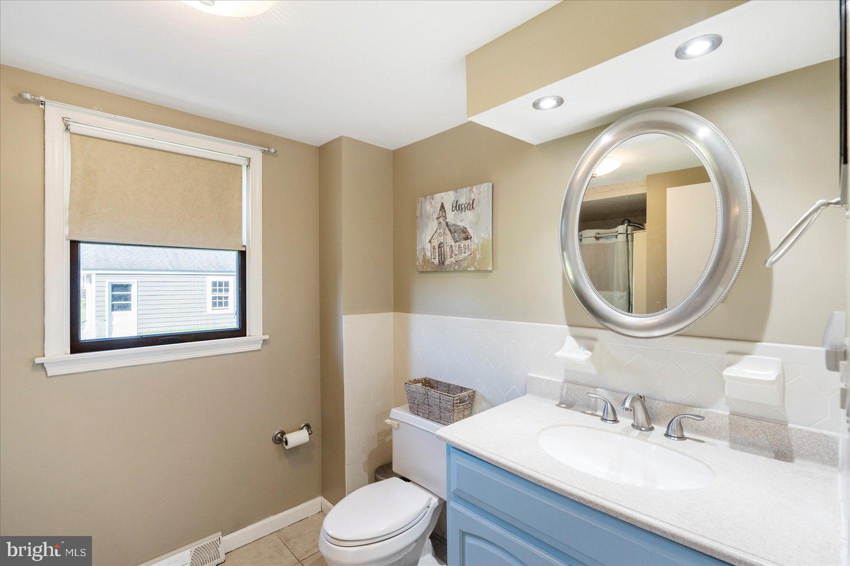 972 Bird River Beach Road Middle River, MD 21220 - Photo 30 of 50 a bathroom with a toilet a sink and mirror