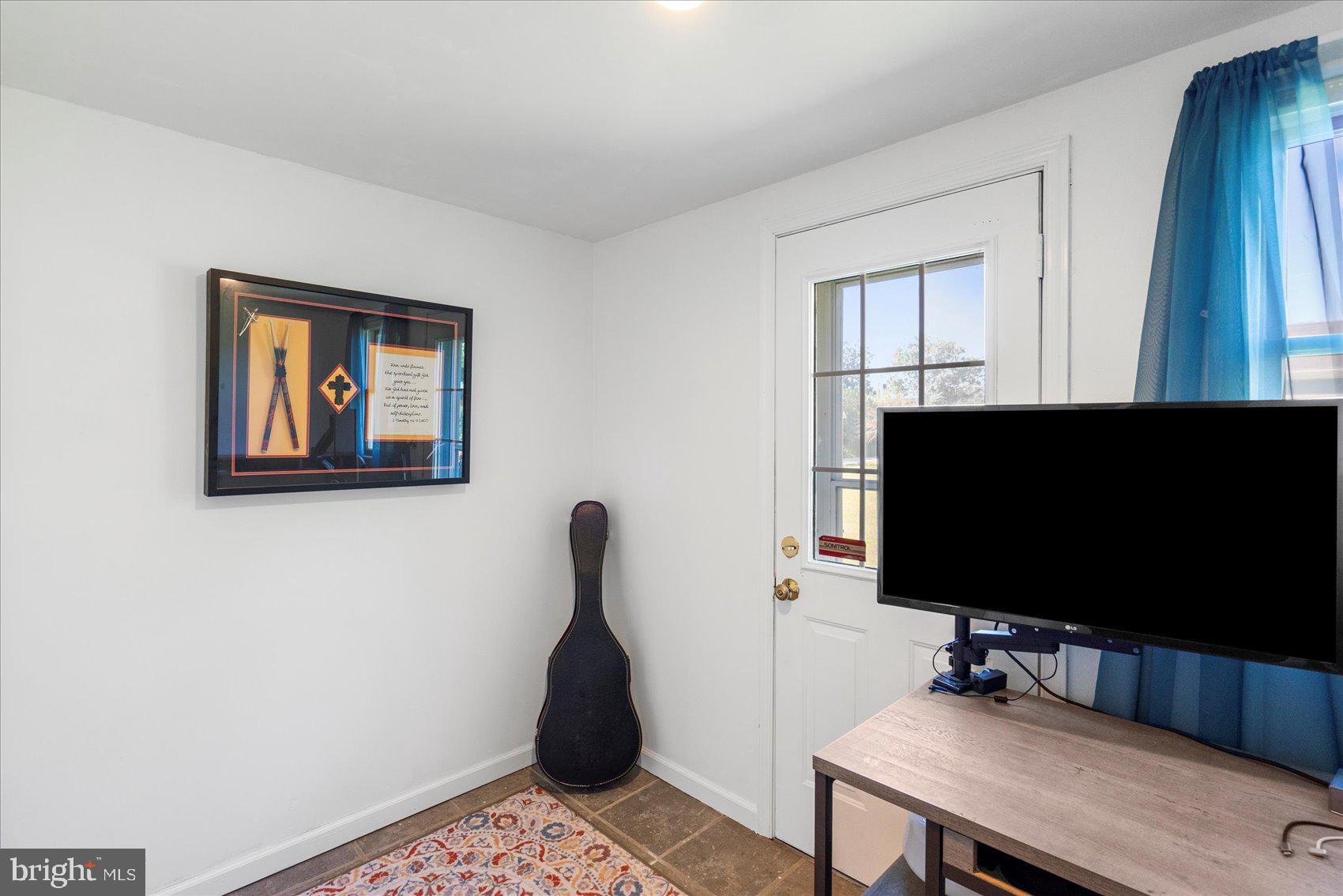 972 Bird River Beach Road Middle River, MD 21220 - Photo 33 of 50 a living room with furniture and a flat screen tv