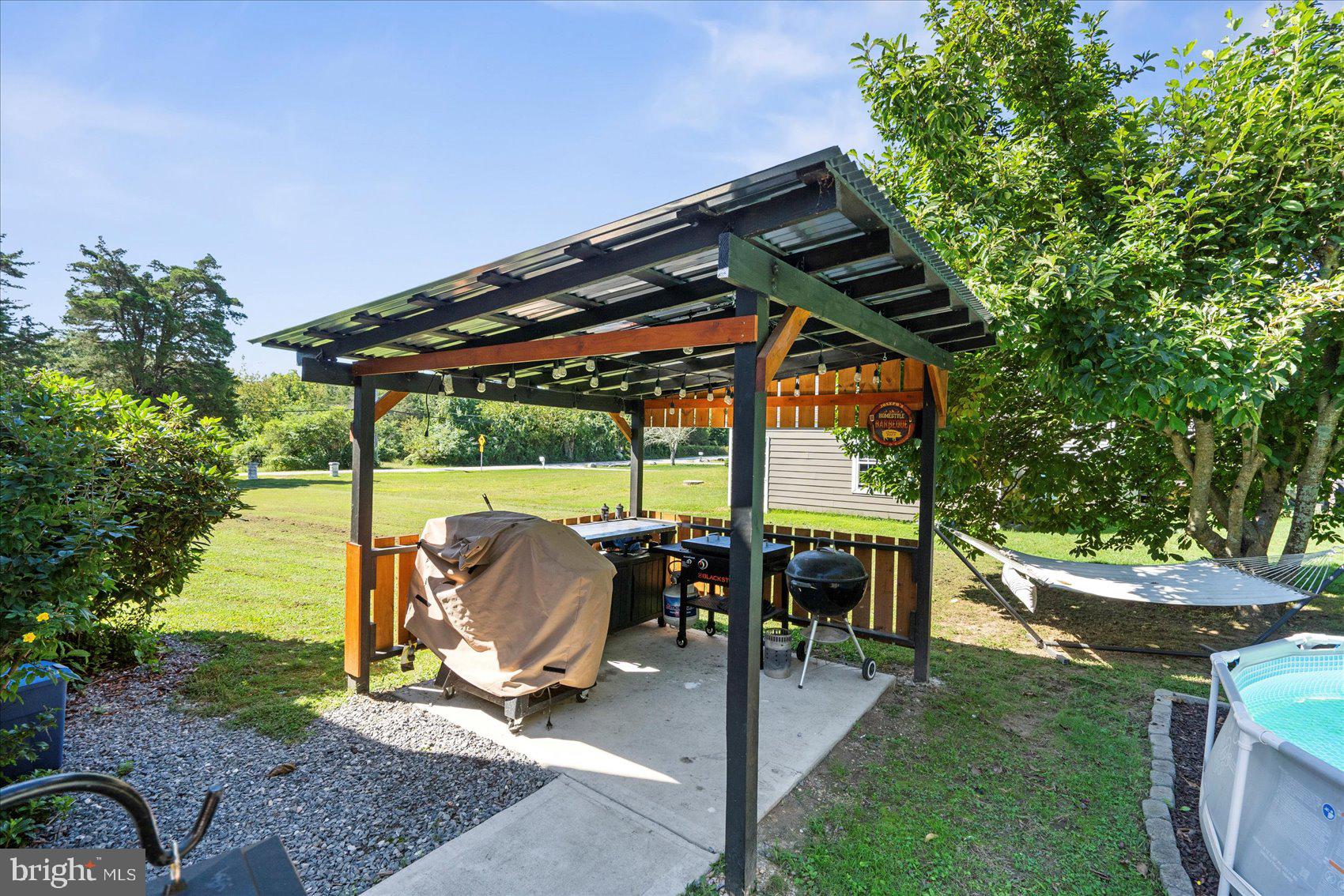 972 Bird River Beach Road Middle River, MD 21220 - Photo 37 of 50 a patio with a yard table and chairs