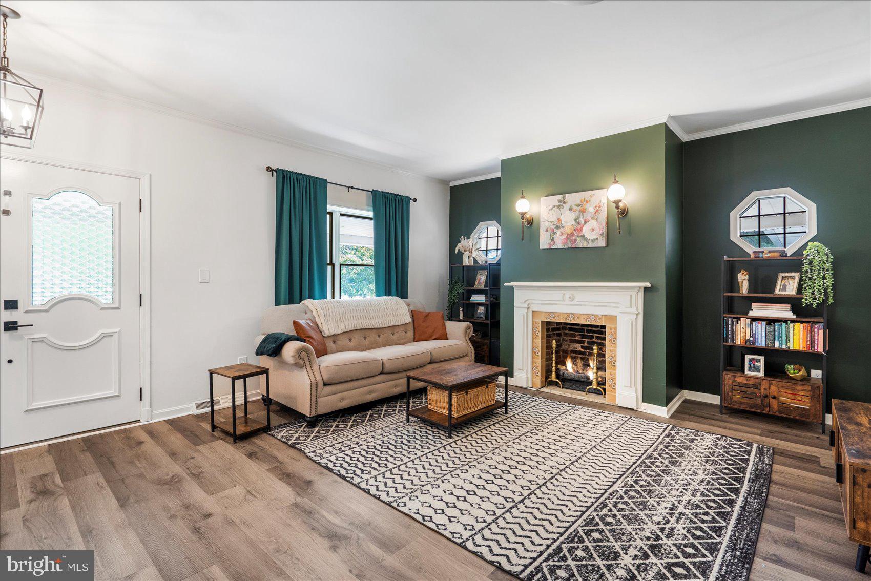 972 Bird River Beach Road Middle River, MD 21220 - Photo 6 of 50 a living room with furniture a flat screen tv and a fireplace