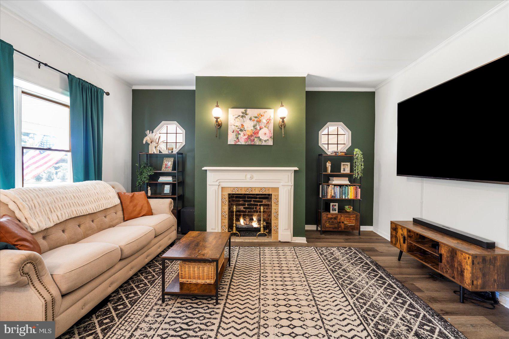 972 Bird River Beach Road Middle River, MD 21220 - Photo 7 of 50 a living room with furniture a flat screen tv and a fireplace
