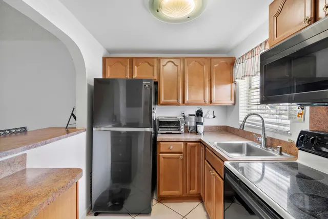 a kitchen with a refrigerator stove and sink