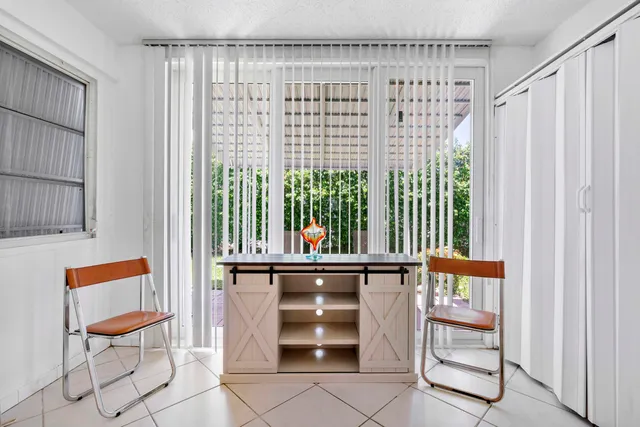 a view of entryway with a window and a kitchen view