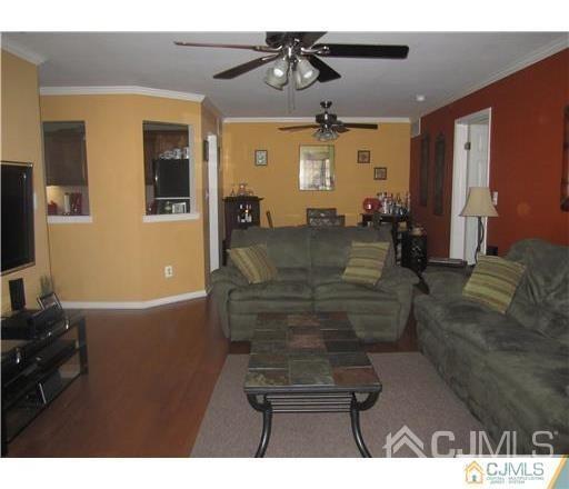 310 Raintree Court Helmetta, NJ 08828 - Photo 2 of 8 a living room with furniture and a chandelier