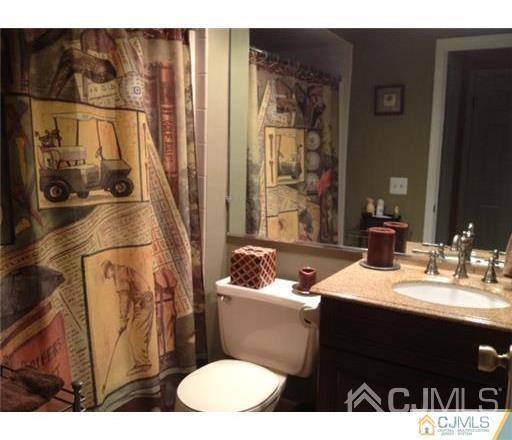 310 Raintree Court Helmetta, NJ 08828 - Photo 5 of 8 a bathroom with a sink toilet and shower