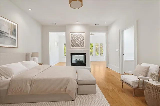 an empty room with wooden floor and fireplace