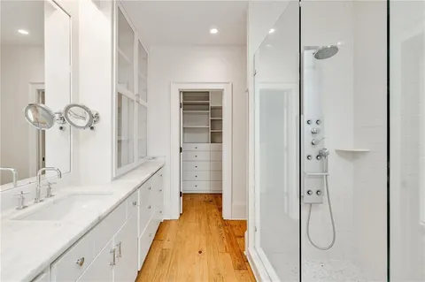a spacious bathroom with a tub sink and mirror
