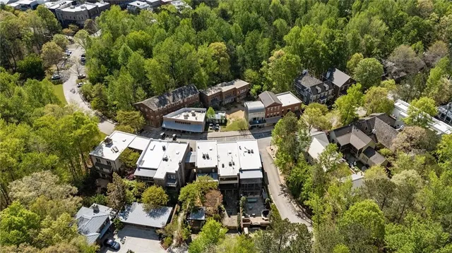 a view of a city with lush green forest
