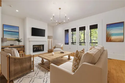 a living room with furniture fireplace and flat screen tv