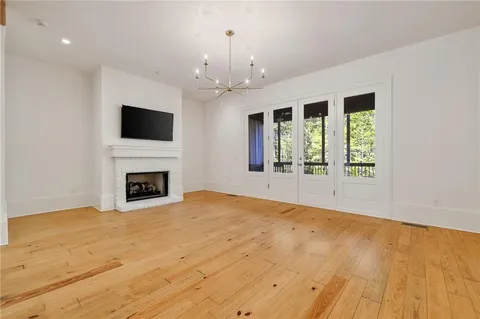a view of an empty room with a fireplace and a window