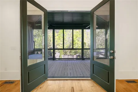 a view of a room with wooden floor and windows