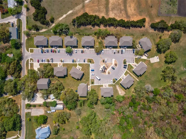 an aerial view of residential houses with outdoor space