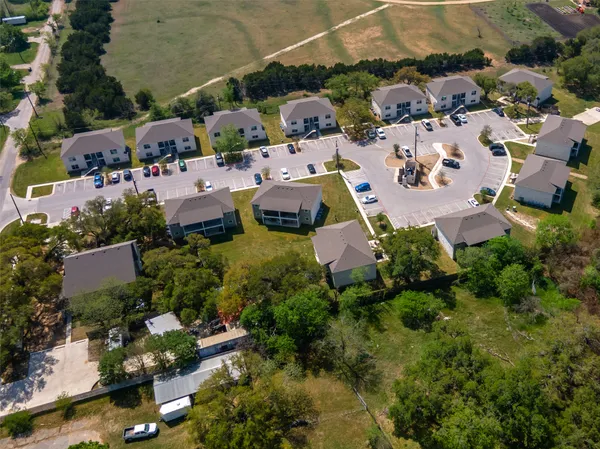 an aerial view of a houses with a yard