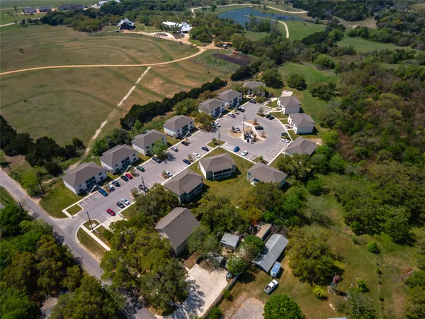 an aerial view of residential houses with outdoor space