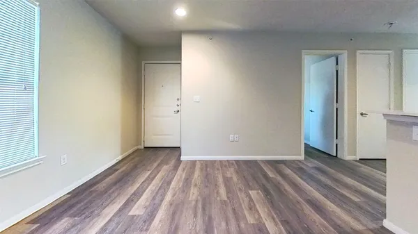 a view of a room with wooden floor