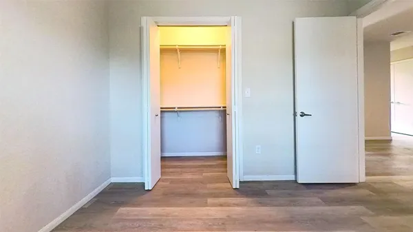 an empty room with closet and a window
